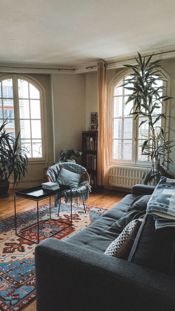 Stylish living room featuring modern furniture, indoor plants, and soft lighting.